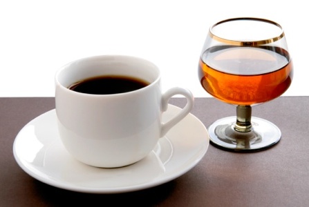 cup of hot coffee and brandy in small glass